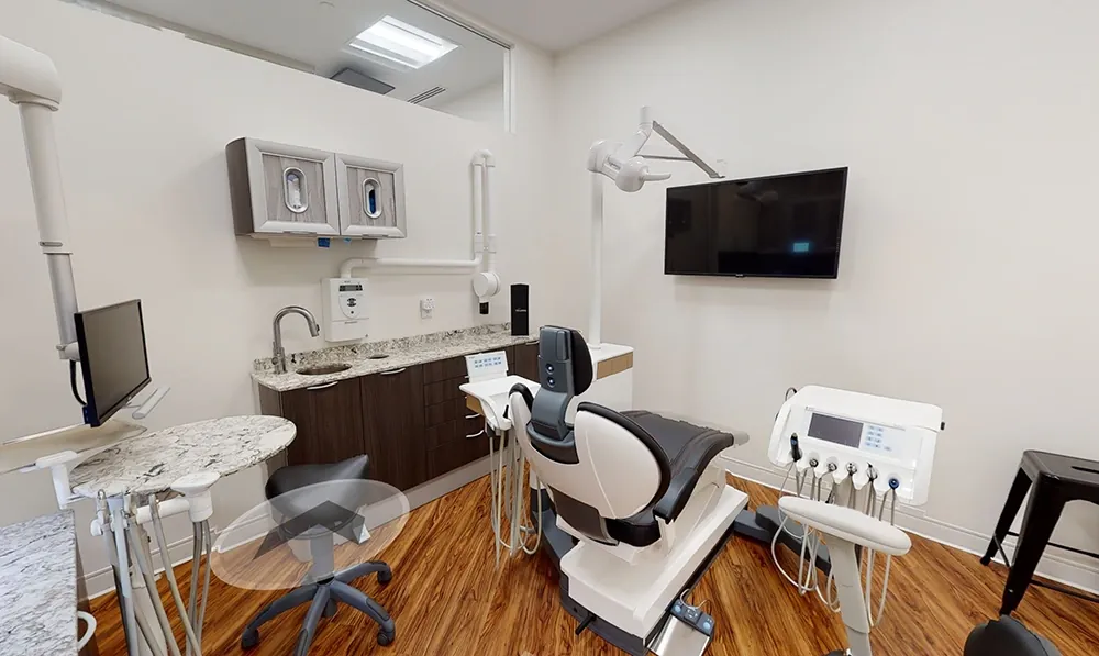 A Main Street treatment room with chair, monitor and cabinetry