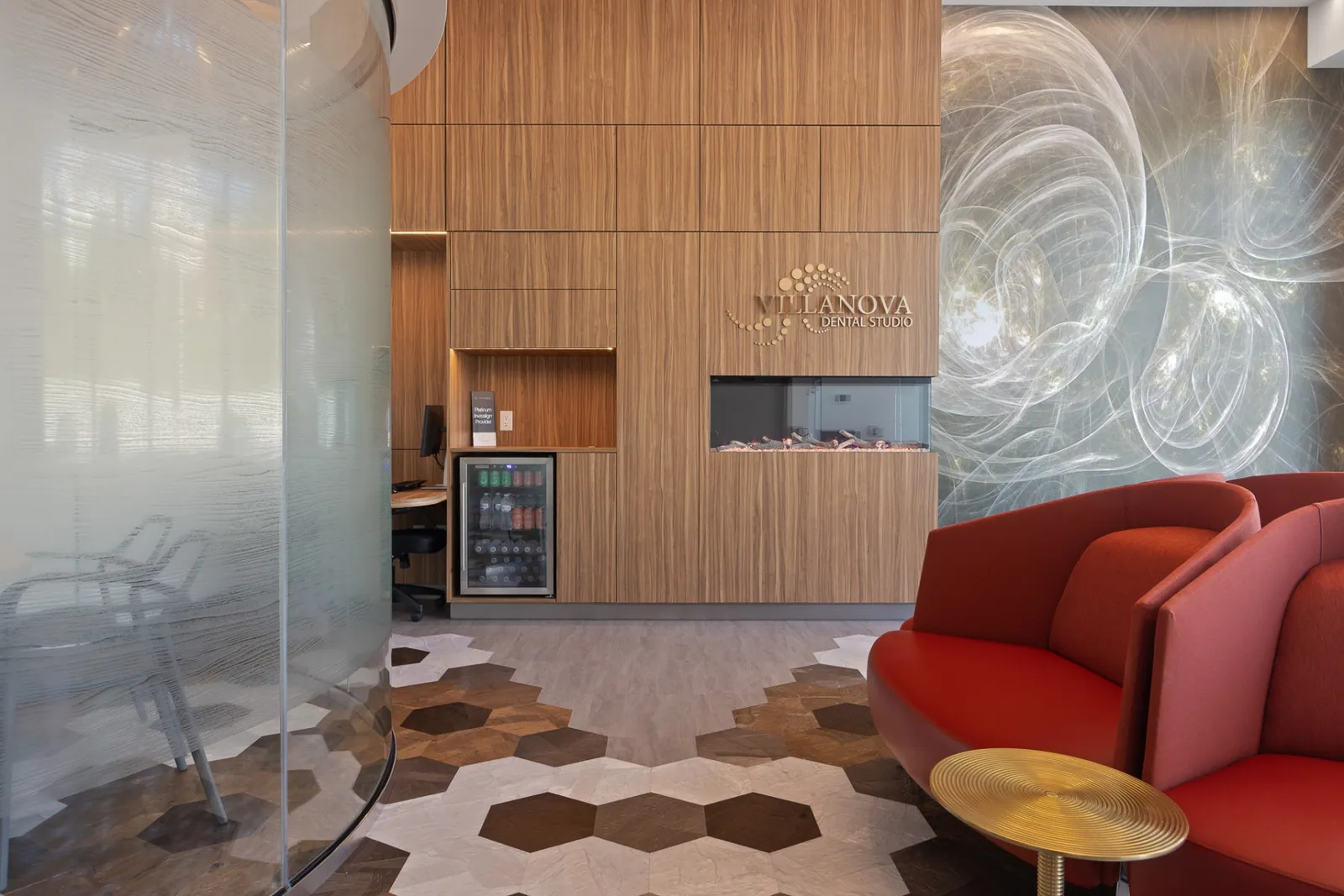 The Terry Fox reception with wood panelling, the Villanova logo, an aquarium and red lounge chairs