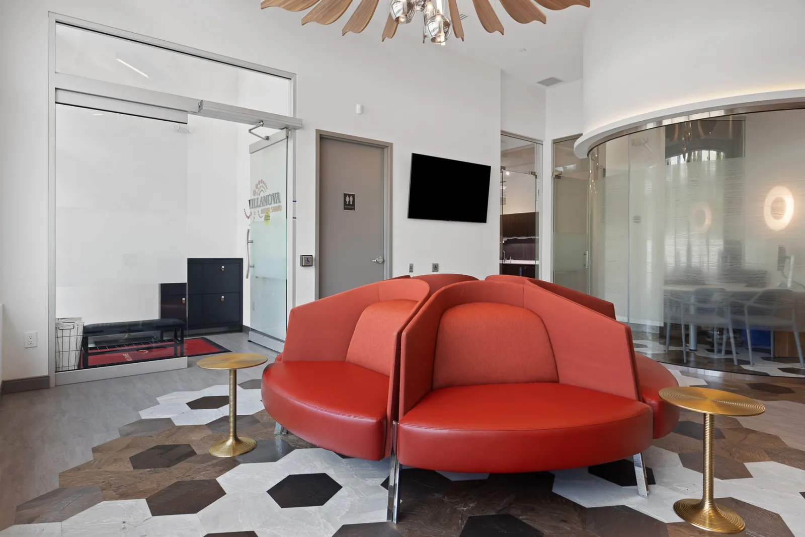The Terry Fox waiting lounge with curved red sofas and hexagon floor tiles